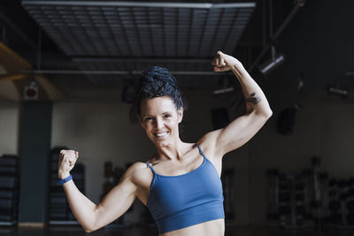 Midsection of woman with arms raised