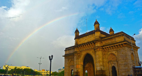 Low angle view of rainbow over building