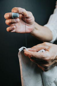 Cropped hand of person holding needle