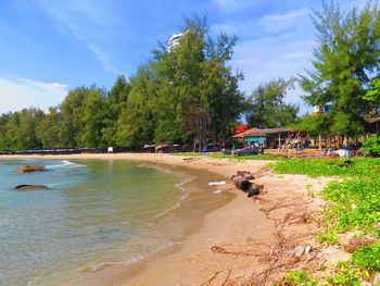 People at beach against sky