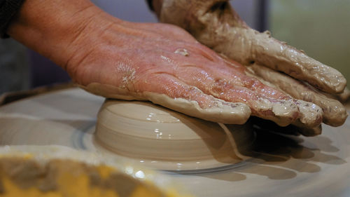 Close-up of man making pottery