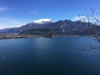 Scenic view of lake and mountains against blue sky