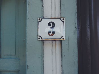 Close-up of number 3 on door