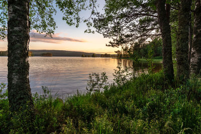 Scenic view of lake against sky at sunset