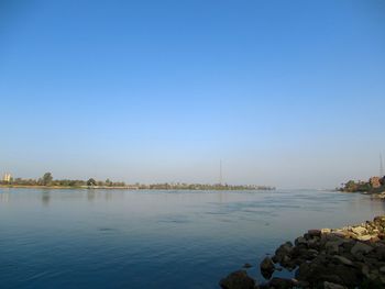 Scenic view of sea against clear blue sky