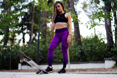 Woman with braids using her skateboard