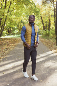 Portrait of young man standing on road