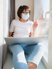 Woman works remotely with laptop  from home. lockdown quarantine because of coronavirus covid19.