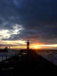 Pier on sea at sunset