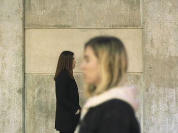 Shadow of woman standing against wall