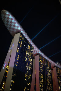 Low angle view of illuminated building against sky at night