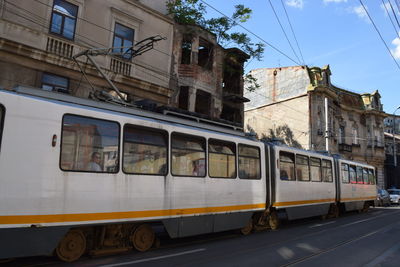 View of tram along buildings