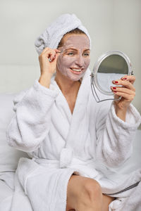 Close-up of young woman with facial mask