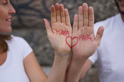 Midsection of people on hands