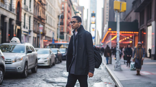 Portrait of man standing on street in city