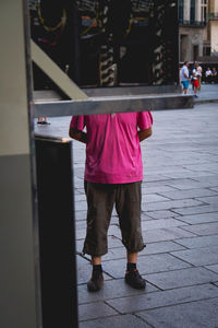 Rear view of woman standing on street