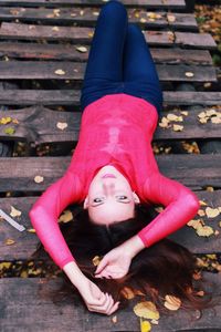 Portrait of young woman sitting on bench