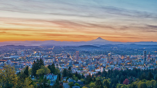 Aerial view of townscape against sky during sunset