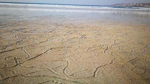 High angle view of wet sand on beach