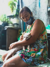 Full length of woman sitting outdoors