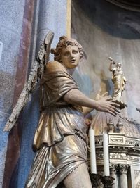 Low angle view of angel statue against temple