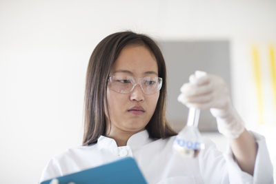 Scientist female with lab glasses and tablet in a lab