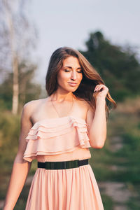 Woman looking away while standing outdoors