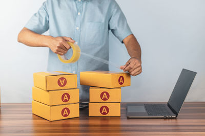 Midsection of man holding toy blocks on table