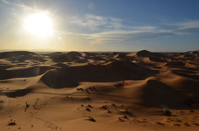 Scenic view of desert against sky during sunset