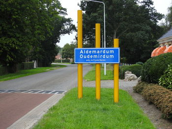 Road sign by trees