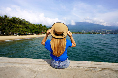 Rear view of woman sitting enjoying peaceful view escaping from city stress.