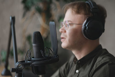 Midsection of man holding microphone