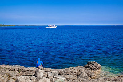 Lonely person contemplating a cruise ship