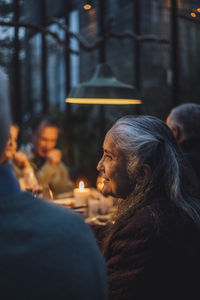 Senior woman amidst friends at dinner party