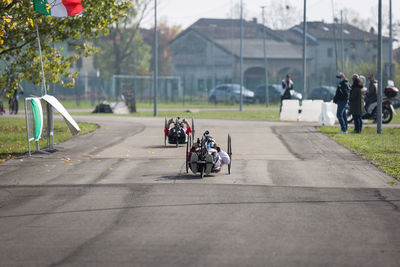 Couple of disabled athlete training with their handbikes on a track.