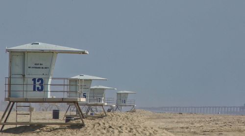 Lifeguard huts at beach against clear sky