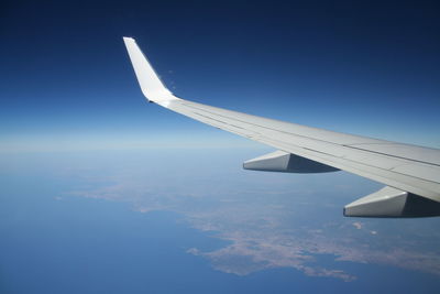 Aerial view of aircraft wing against sky