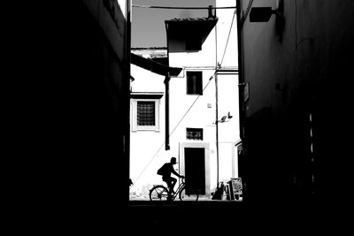 Low angle view of people walking in front of building
