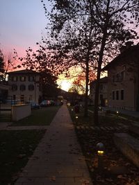 Empty footpath at sunset