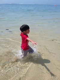 Full length of girl standing on beach