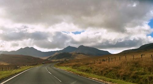 Panoramic view of road by mountains against sky