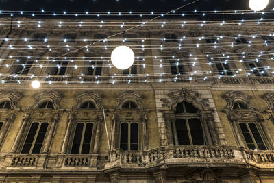 Low angle view of illuminated building at night