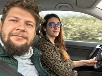 Portrait of happy young woman in car