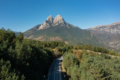 High angle view of trees and mountains against clear blue sky