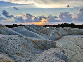 Scenic view of land against sky during sunset