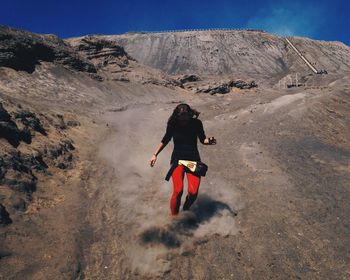 Full length of woman standing on mountain