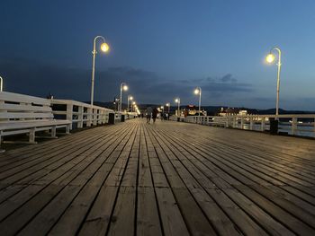 View of empty footpath at night