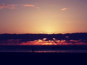 Scenic view of sea against orange sky