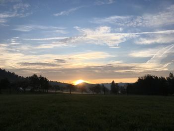 Scenic view of field against sky during sunset