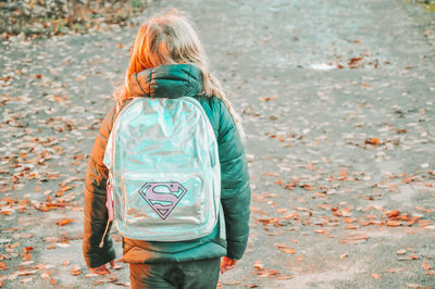 Rear view of woman standing in autumn